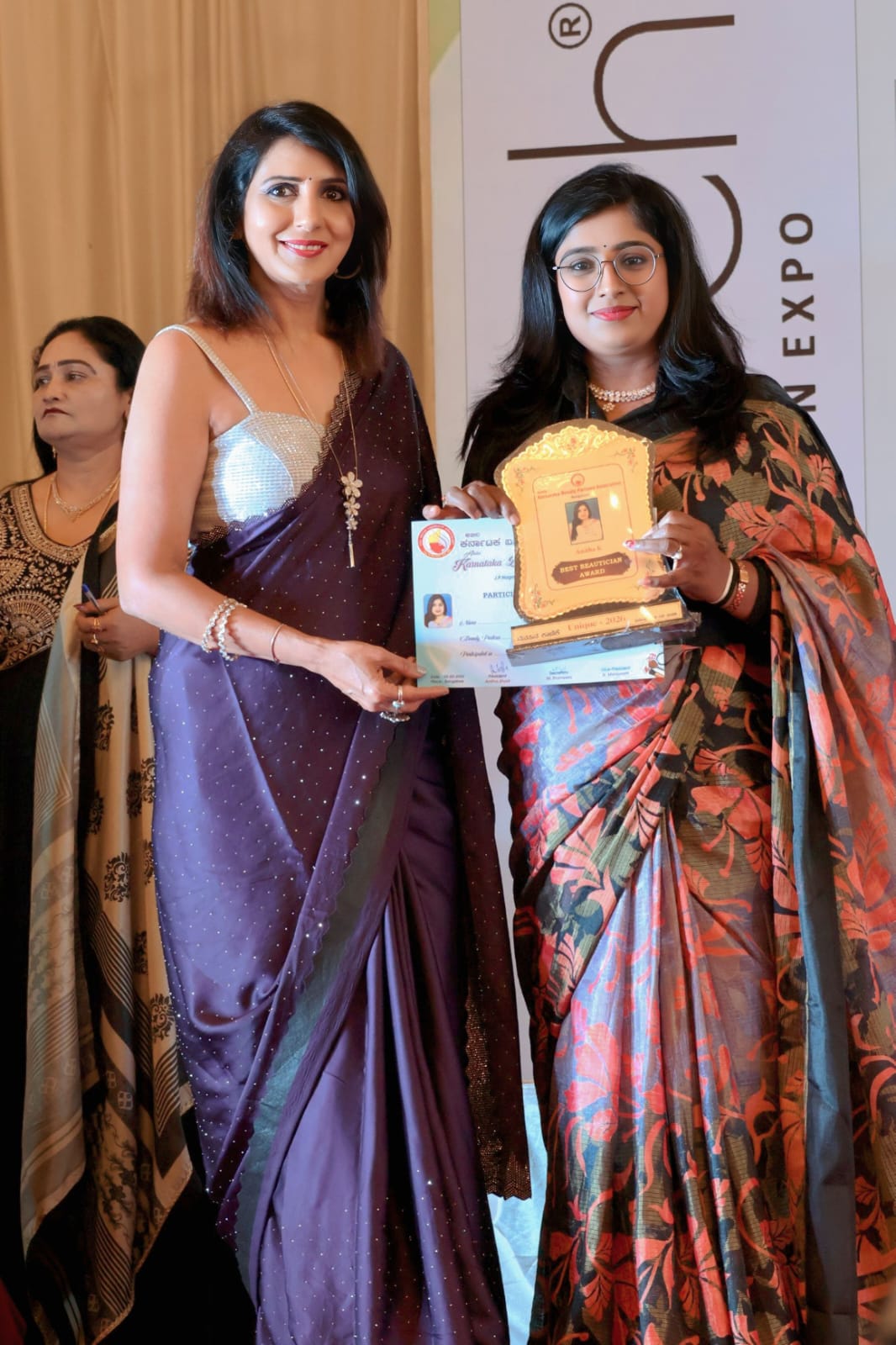 KB Anitha receiving the Best Beautician award