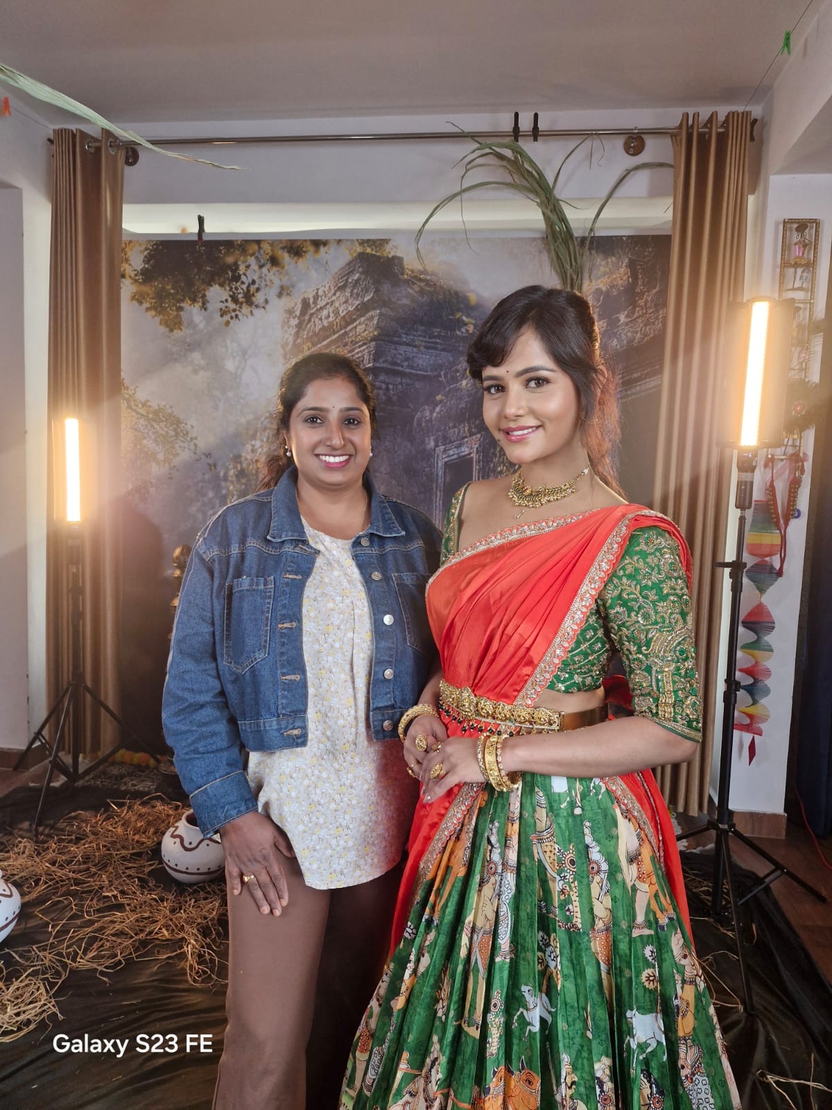 Client styled in a festive green and orange lehenga